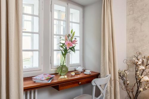 a vase of flowers sitting on a table next to a window at Monastery Garden Prague in Prague