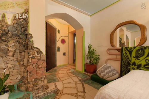 a bedroom with a stone wall next to a bed at Kyzyl-Armeyskaya Guest House in Kazan