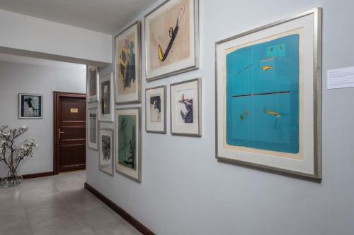 a hallway with framed pictures on a wall at Monastery Garden Prague in Prague