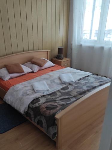 a bedroom with a large bed with two pillows at Agroturystyka u Zosi in Żegiestów