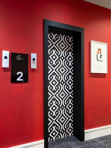 a wall with a black and white door with a red wall at Elizabeth Lifestyle Hotel in Bologna