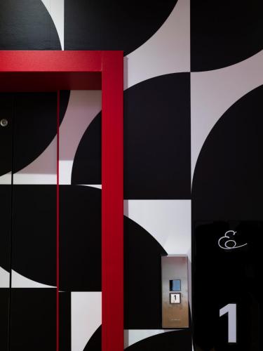 a red ribbon on a black and white checkered wall at Elizabeth Lifestyle Hotel in Bologna