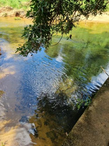 a body of water with a person swimming in it at JAYANDRA HOLIDAY BUNGALOW in Waga