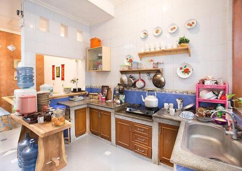 a kitchen with a sink and a counter top at Liem Hostel Malioboro in Sentool