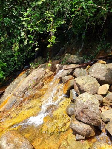 a stream of water on top of some rocks at JAYANDRA HOLIDAY BUNGALOW in Waga