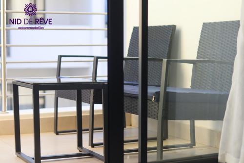 a table and two chairs in front of a window at Nid de Rêve Accommodation in Midrand