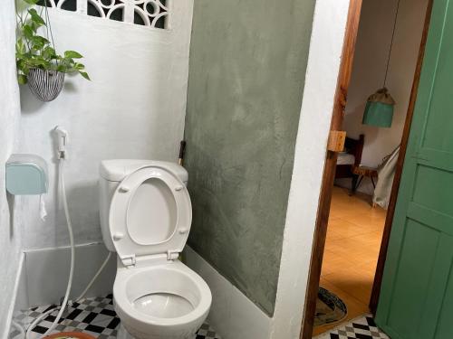邦美蜀的住宿－Cọ Cùn homestay/Handmade/Artwork，一间带卫生间和绿门的浴室