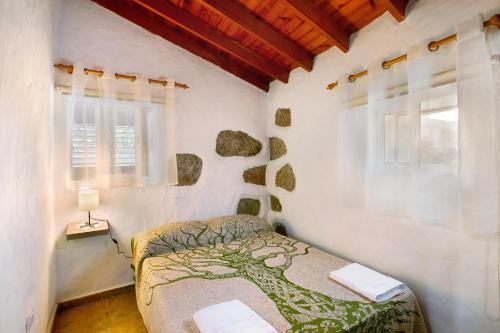 1 dormitorio con 1 cama en una habitación blanca en Vv Casa Frasquita en San Bartolomé