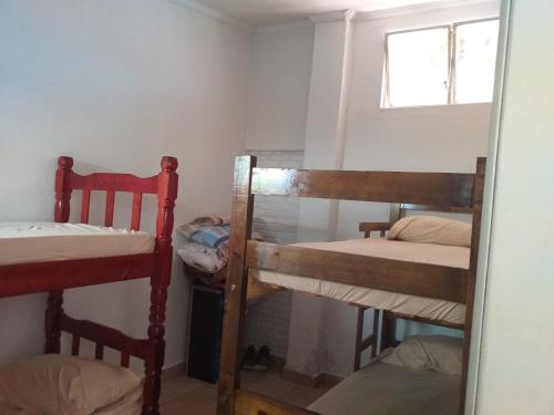 two bunk beds in a room with a window at BIMBA HOSTEL - UNIDADE 03 - GOIÂNIA - GO in Goiânia