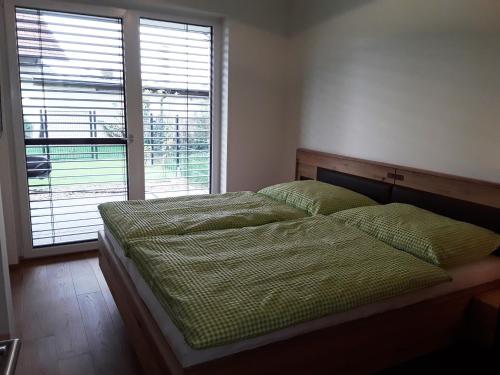 a bedroom with a bed and a large window at Apartment Kristall Real in Bad Radkersburg