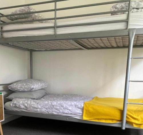 a bedroom with two bunk beds with yellow sheets at Fernando's place in Dublin