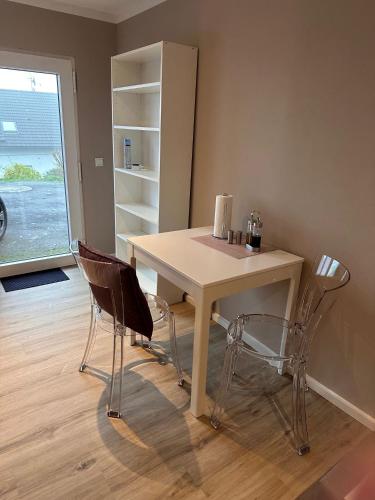 a table and two chairs in a room at Appartement 2 Birkenhof in Drolshagen