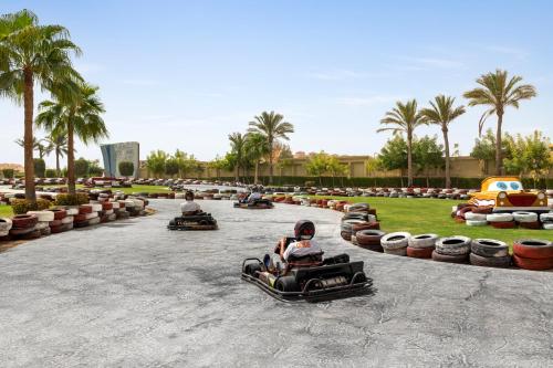 a group of people riding in bumper cars on a race track at Rixos Premium Seagate in Sharm El Sheikh