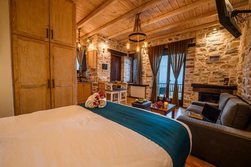 a bedroom with a large bed and a living room at Mple Feggari in Mouresi