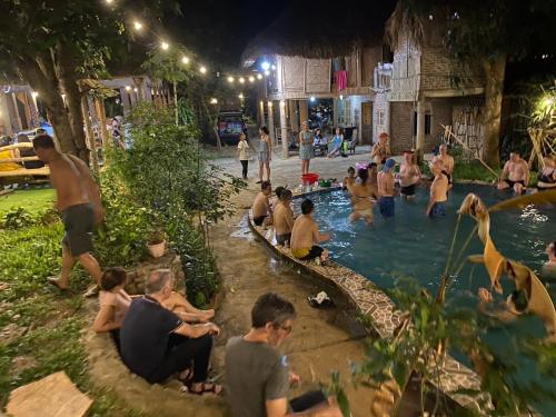 a group of people in a swimming pool at night at MAI HICH FARMSTAY 2 in Mai Hạ