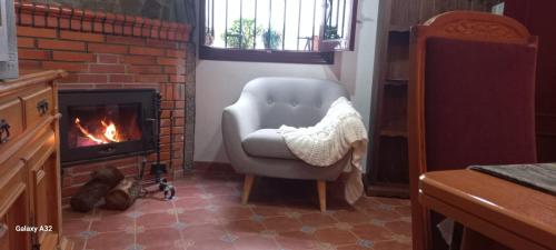 sala de estar con silla y chimenea en Casa Pilar Seco en Laujar de Andarax