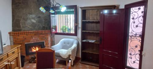 a living room with a chair and a fireplace at Casa Pilar Seco in Laujar de Andarax