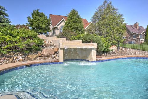 a swimming pool with a waterfall in a yard at Premier Cottages by Amish Country Lodging in Berlin