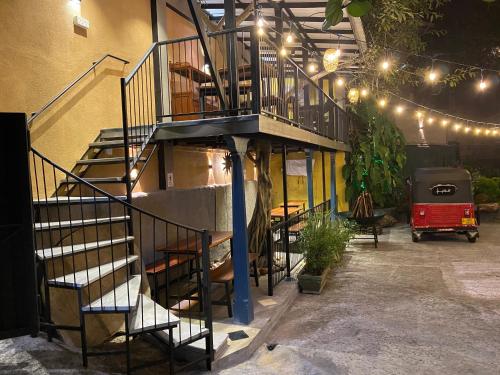 a staircase leading up to a building with lights at Settle Inn Tourist Lodge in Kandy