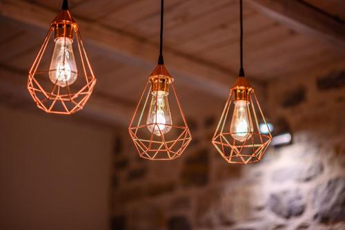 a group of lights hanging from a ceiling at Mple Feggari in Mouresi