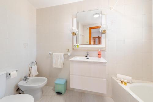 a white bathroom with a sink and a toilet at Villa Cladera in Alcudia Playa de muro beach private pool in Alcudia