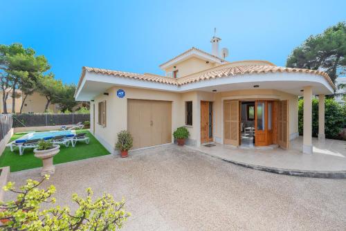 a small house with a patio and a yard at Villa Cladera in Alcudia Playa de muro beach private pool in Alcudia