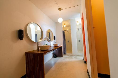 a bathroom with two sinks and a mirror at Juliette Hostel Digital Nomad Women Only in San Juan