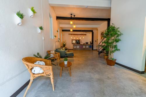 a living room with chairs and plants in a room at Juliette Hostel Digital Nomad Women Only in San Juan