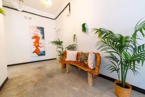 a couch in a room with plants and paintings at Juliette Hostel Digital Nomad Women Only in San Juan