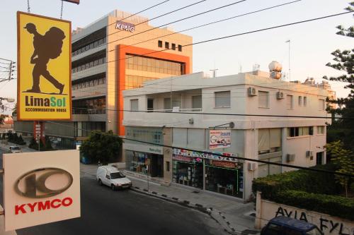 a city street with buildings and a car on the road at Lima Sol House in Limassol