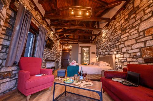 a room with a bed and a couch and a table at Mple Feggari in Mouresi