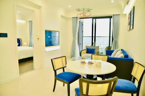 a living room with a table and chairs and a bedroom at Emely Lucky Apartment Phu Quoc in Phu Quoc