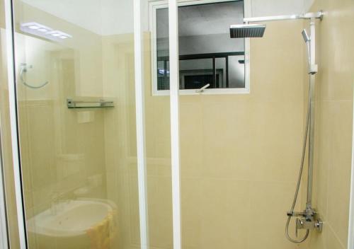 a bathroom with a shower and a sink at Kurundu Wadiya (Cinnamon Retreat) in Hikkaduwa