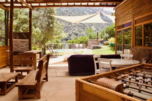 a patio with tables and chairs and a view of a pool at Loft de montaña Los Guayacanes in San José de Maipo