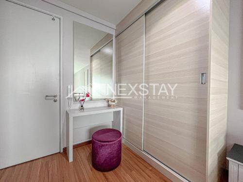 a dressing room with a vanity and a mirror at Cozy i-City Duplex Getaway by Nexstay in Shah Alam