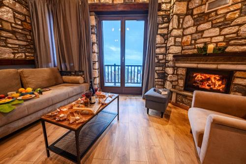 a living room with a couch and a fireplace at Mple Feggari in Mouresi