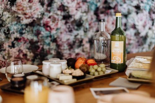 a table with a plate of food and a bottle of wine at Biohof Ebengut in Maria Alm am Steinernen Meer