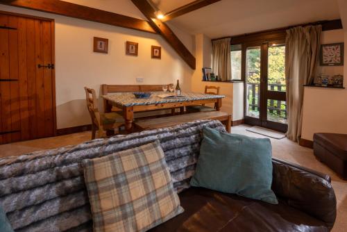 a living room with a couch and a table at The Coach House, Skelwith Bridge in Grasmere