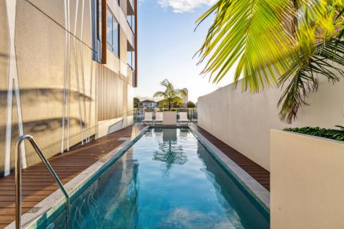 a swimming pool in the middle of a building at The Riverview - Brand New Modern 2BR with King Bed, Parking & Pool in Gold Coast