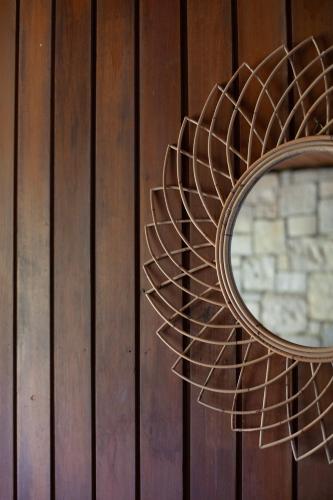 a mirror hanging on a wooden wall at Frenchman's Cove Resort in Port Antonio