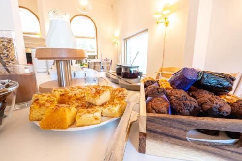 a table with two plates of bread and pastries at Logierhaus am Rathaus in Norderney