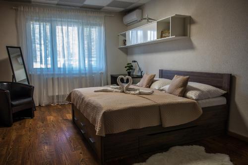 a bedroom with a large bed with a large window at AeroCafe in Partizánske