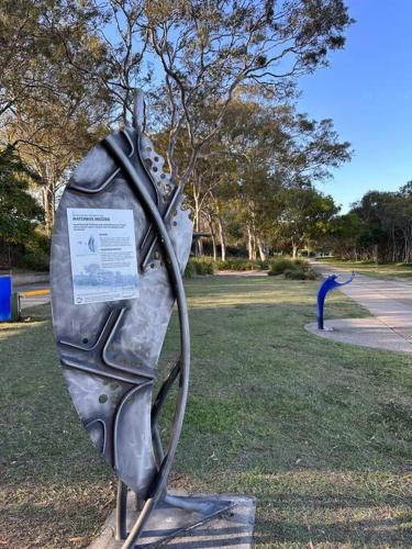 a metal statue of a person with a bird at Gardens by the Bay - Acreage Living & EV Charging in Deception Bay