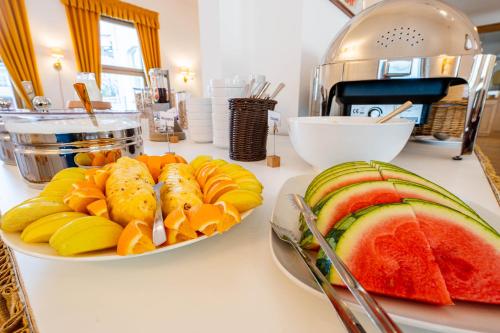 a table with two plates of fruit on a counter at Logierhaus am Denkmal in Norderney