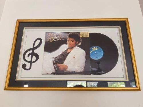 a framed picture of a guitarist and a cd at Gardens by the Bay - Acreage Living & EV Charging in Deception Bay