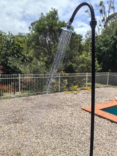 a water fountain in a park with a playground at Gardens by the Bay - Acreage Living & EV Charging in Deception Bay