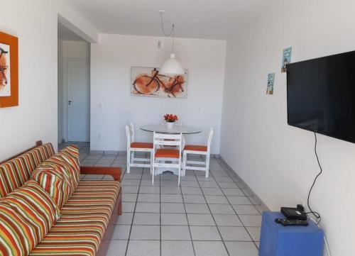 a living room with a couch and a table at Pousada Ingleses Beach in Florianópolis