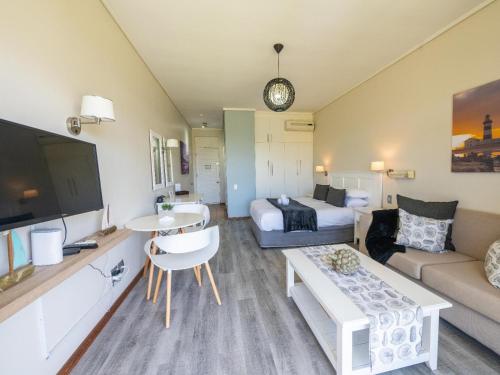 a living room with a bed and a couch at Unit 261 Brookes Hill Suites in Summerstrand
