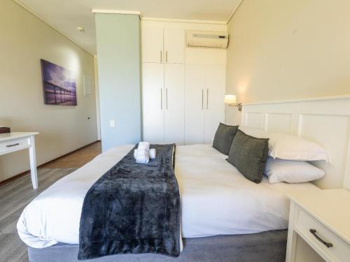 a bedroom with a large white bed in a room at Unit 261 Brookes Hill Suites in Summerstrand