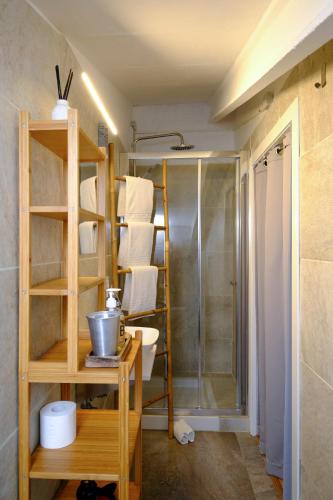 a bathroom with a shower and a toilet and towels at Casa Caimari Guest House, for mountain lovers! in Caimari
